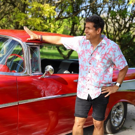 Rafael Aranda posing infront of Chevrole Bel Air.